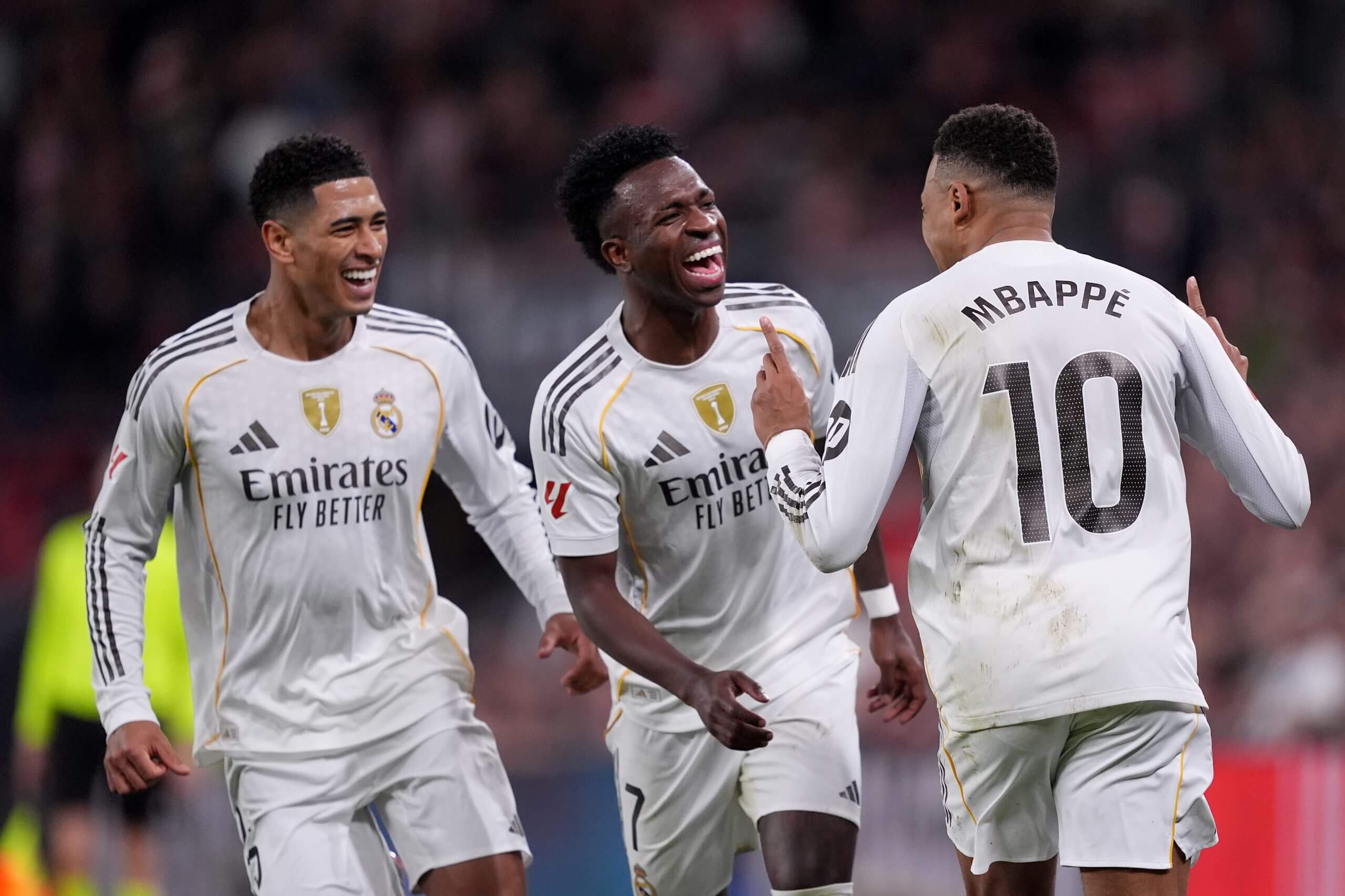 Mbappe celebrates with team-mates Vinicius Jr and Jude Bellingham in December's victory over Athletic Club