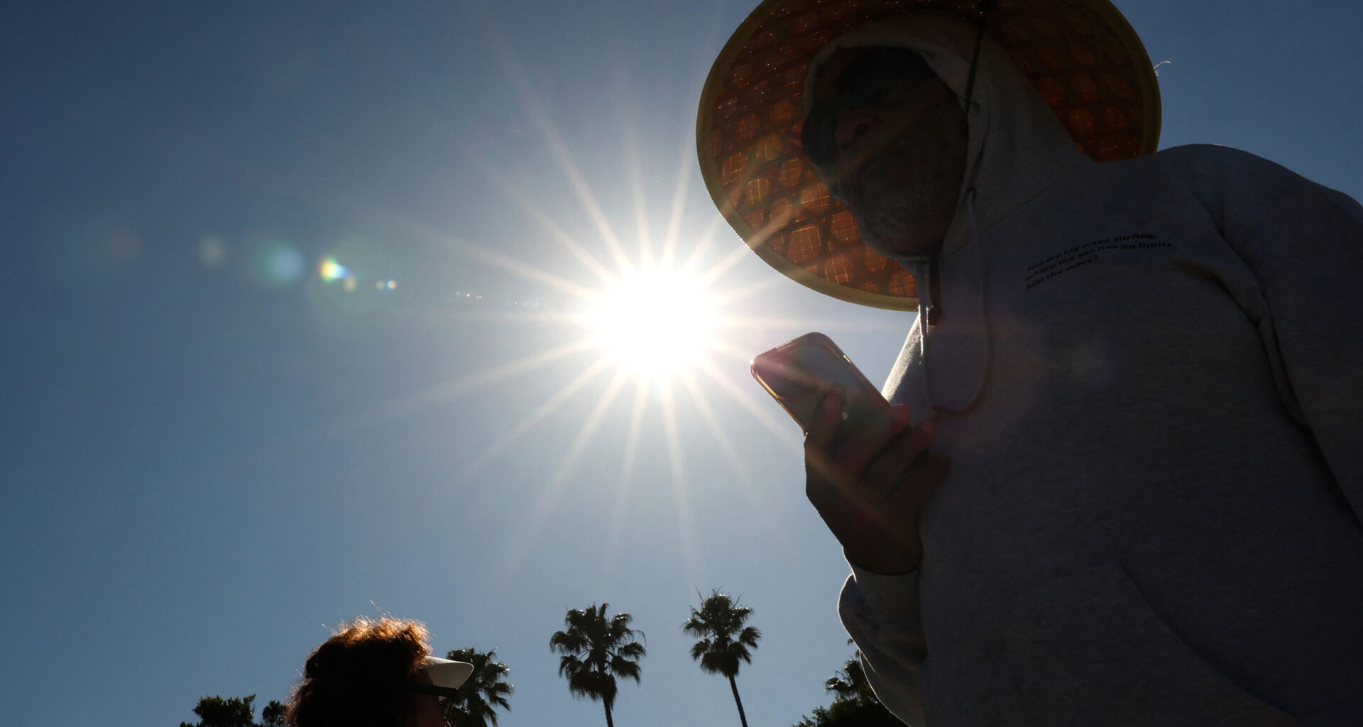 A person wears a hat for shade during a heat wave on March 20 in Redondo Beach, Calif. The March heat wave that blistered the Western U.S. foreshadows more extreme heat this summer, former NOAA climate scientists said in a briefing this week. Credit: Patrick T. Fallon/AFP via Getty Images