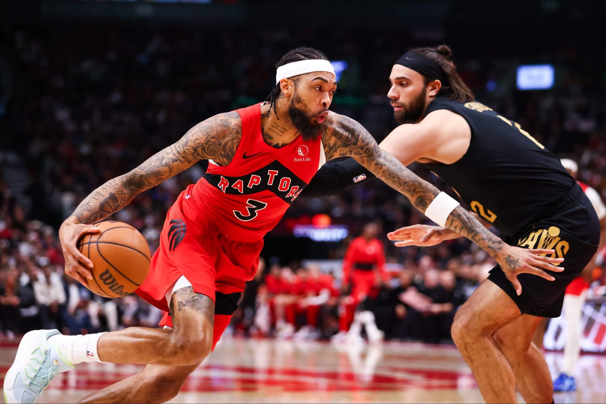 Toronto's Brandon Ingram drives on Cleveland's Max Strus during a playoff game.