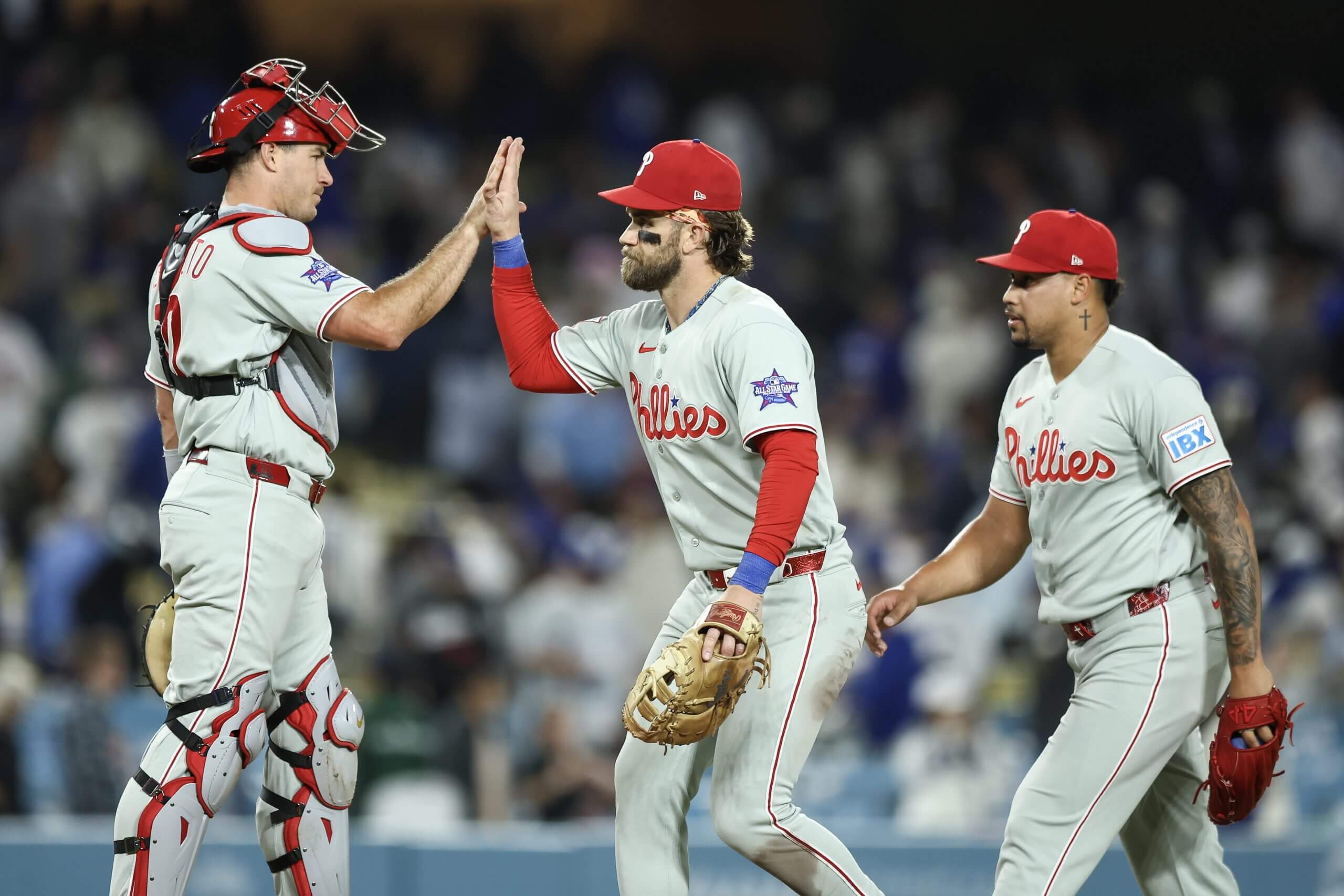 J.T. Realmuto, Bryce Harper, and Jhoan Duran of the Philadelphia Phillies react after defeating the Los Angeles Dodgers at Dodger Stadium on May 30, 2026 in Los Angeles, California.