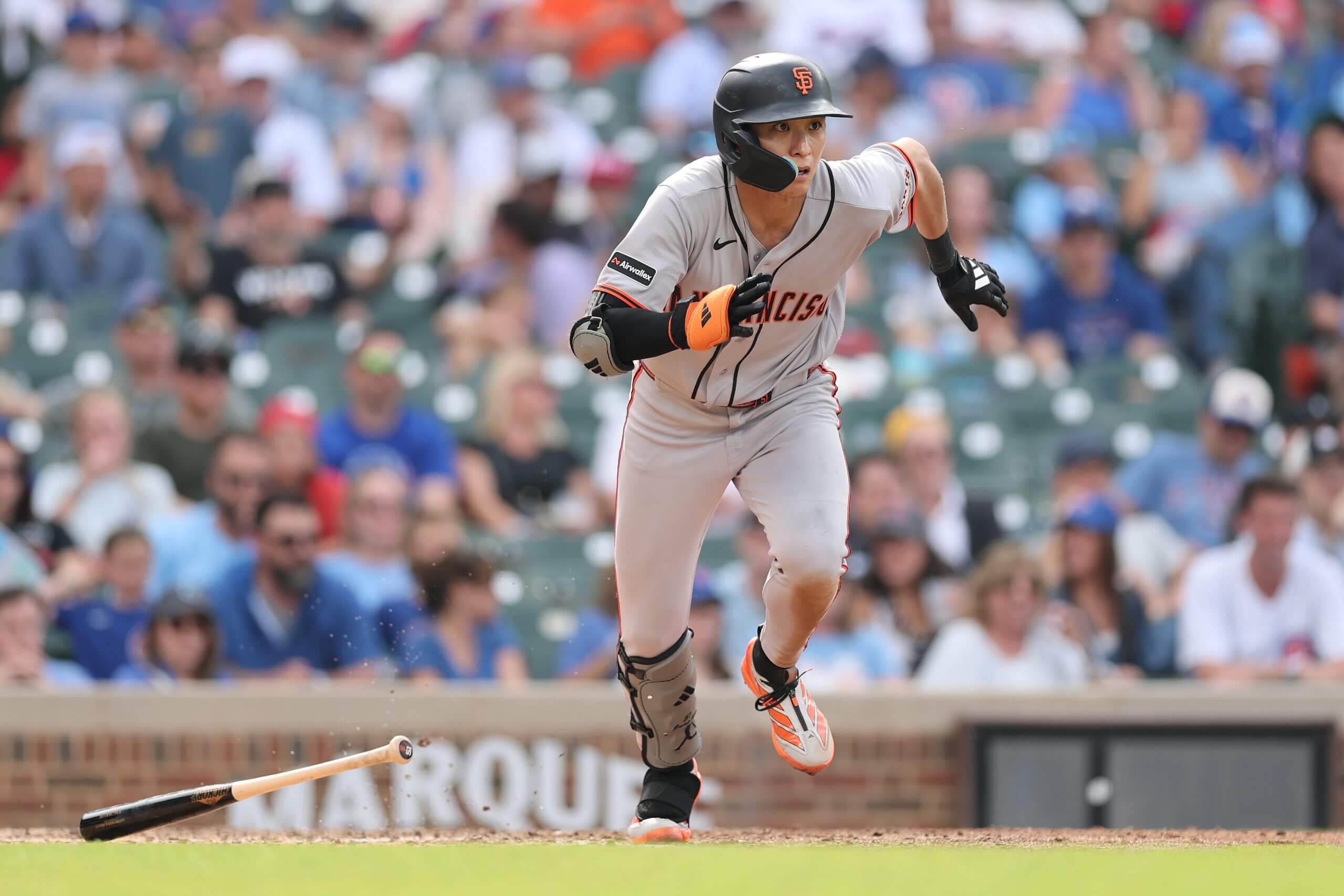 Jung Hoo Lee of the San Francisco Giants runs to first base against the Chicago Cubs at Wrigley Field.