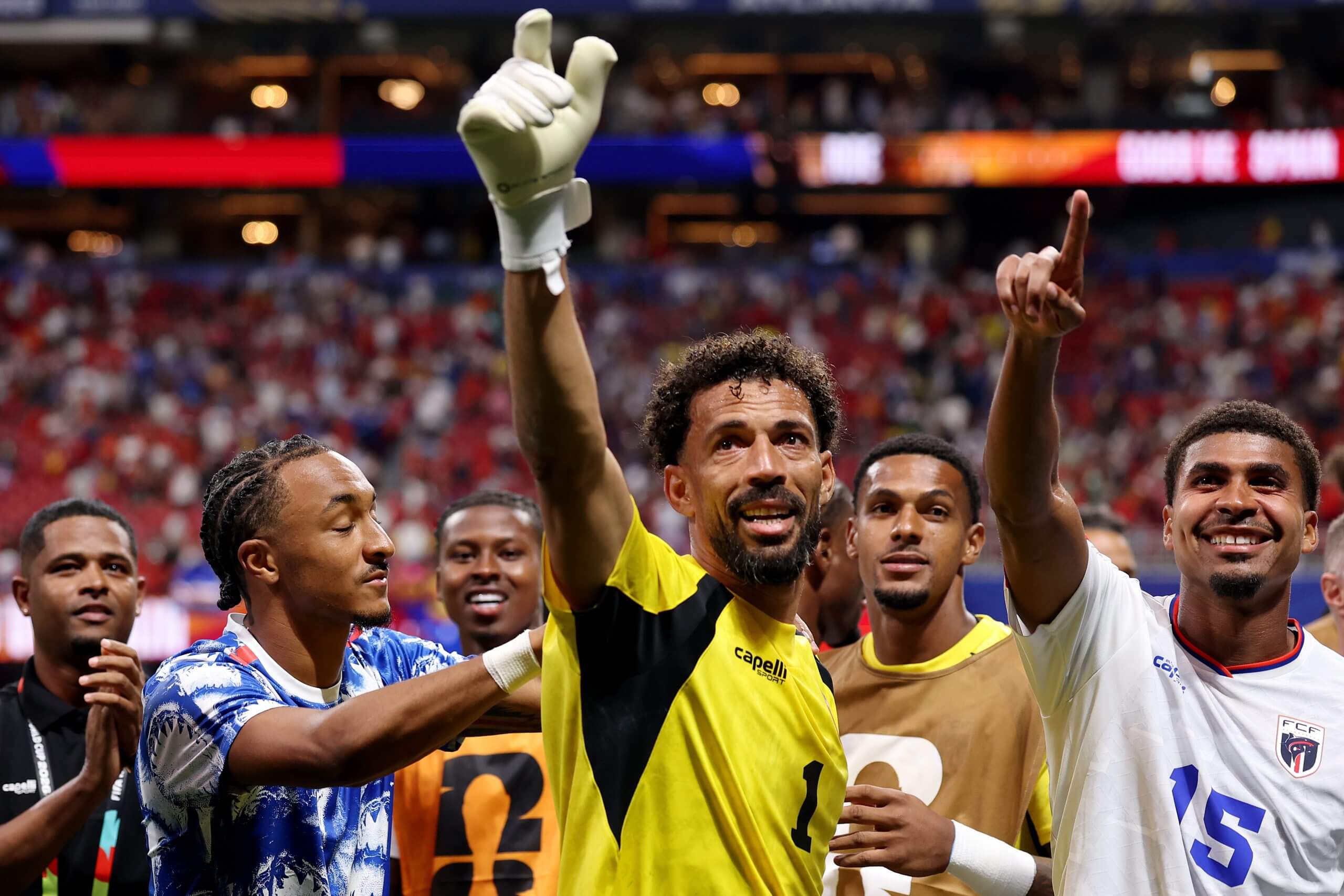 Goalkeeper Vozinha raises his right hand in the air