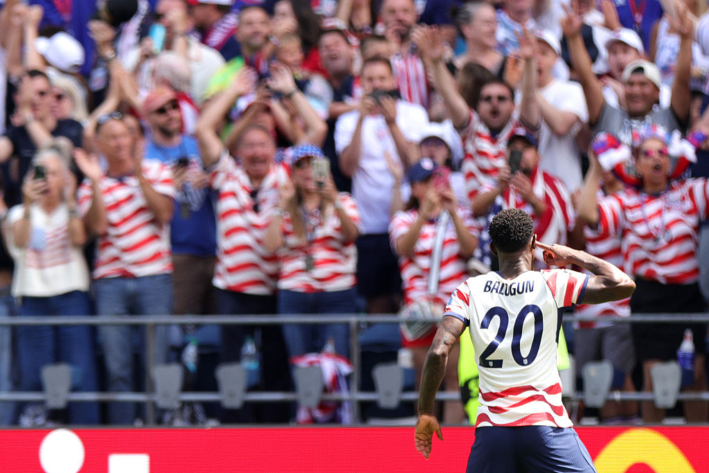 SEATTLE, WASHINGTON - JUNE 19: Folarin Balogun #20 of the United States celebrates the team's first goal scored an own goal by Cameron Burgess #21 (not pictured) of Australia during the FIFA World Cup 2026 Group D match between USA and Australia at Seattle Stadium on June 19, 2026 in Seattle, Washington. (Photo by John Dorton/USSF/Getty Images)