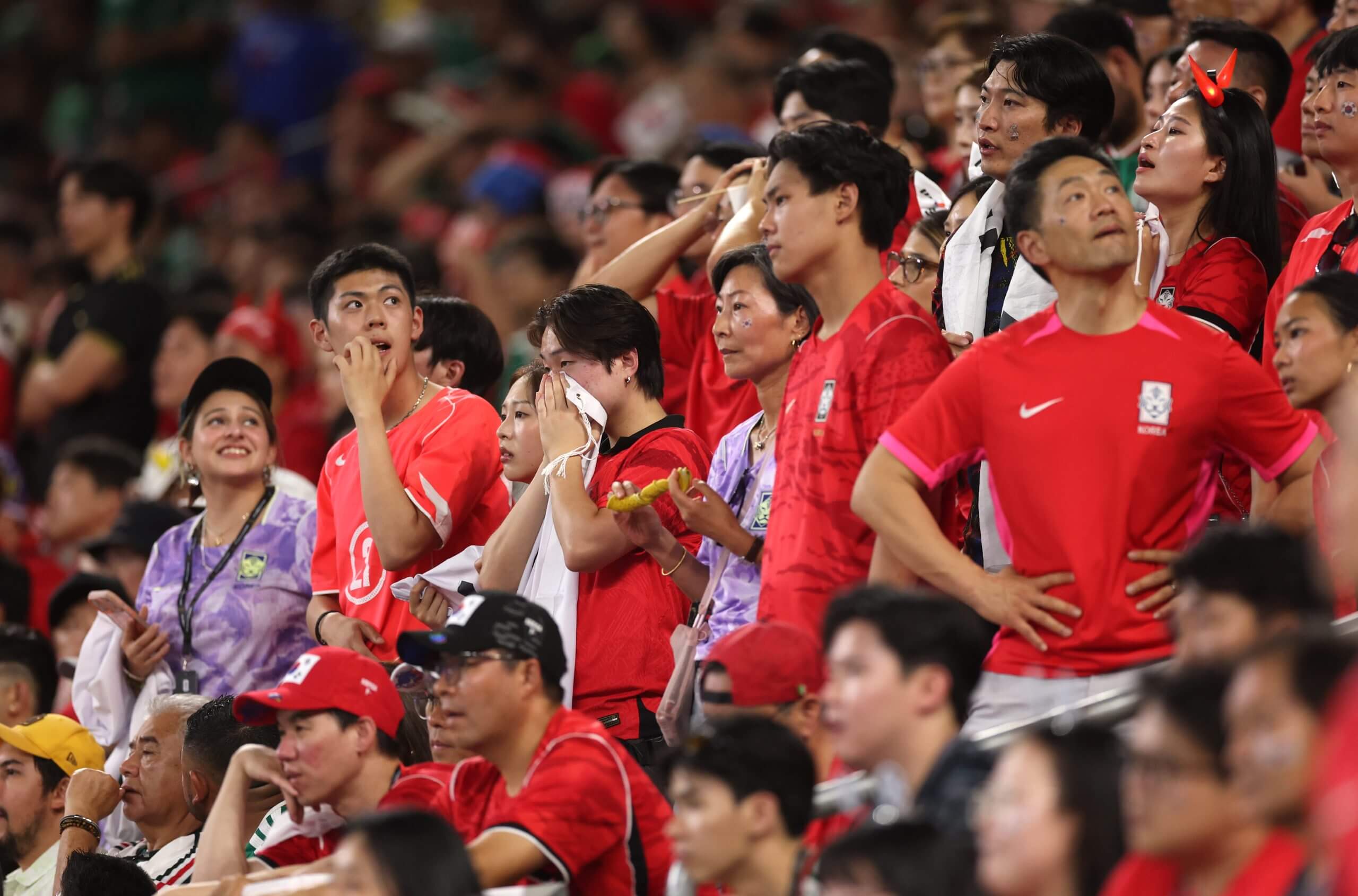 South Korea fans watch on as their side slump to defeat by South Africa