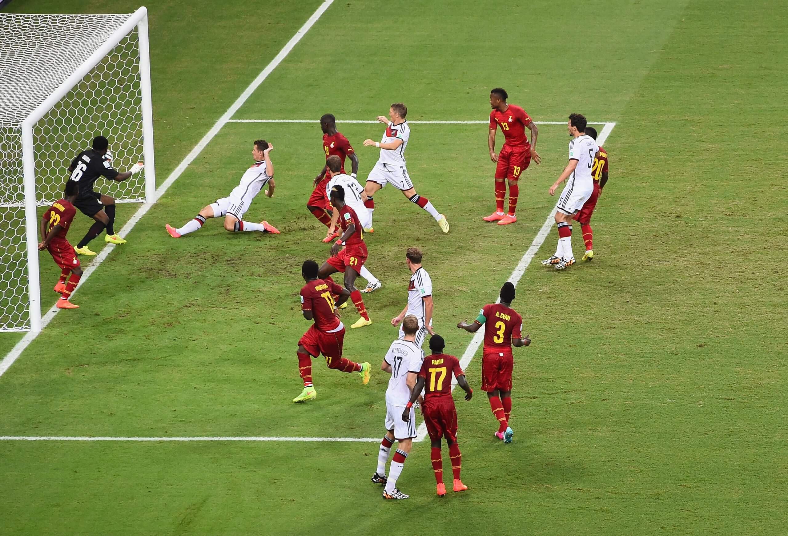 Miroslav Klose of Germany scores his team's second goal past Fatawu Dauda of Ghana in a crowded penalty box