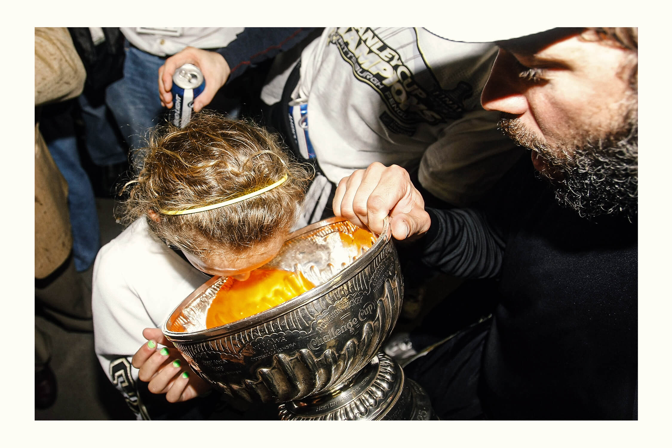 Then-12-year-old Kayla Guerin drinks orange Gatorade from the Stanley Cup's bowl.