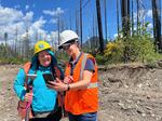 FILE - On the site of the South Fork project, Susan Fricke, right shows Lara Colley an image from the Finn Rock Reach area. Photo taken May 18, 2026.