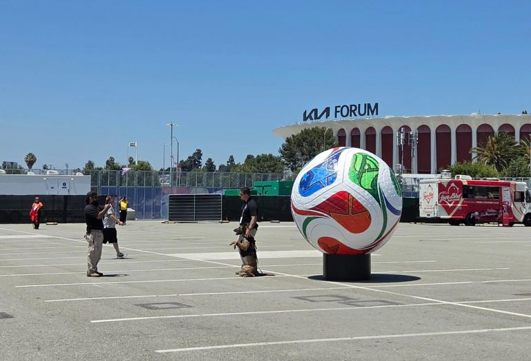 Dog and officer standing next to giant ball