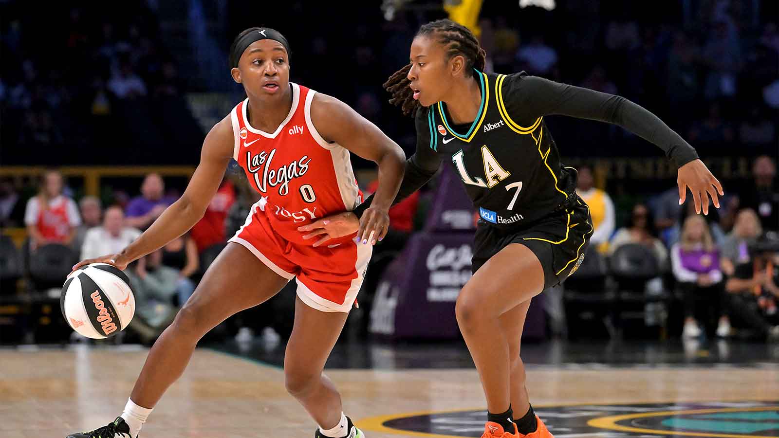 Las Vegas Aces guard Jackie Young (0) is defended by Los Angeles Sparks guard Ariel Atkins (7) during the first half at Crypto.com Arena.
