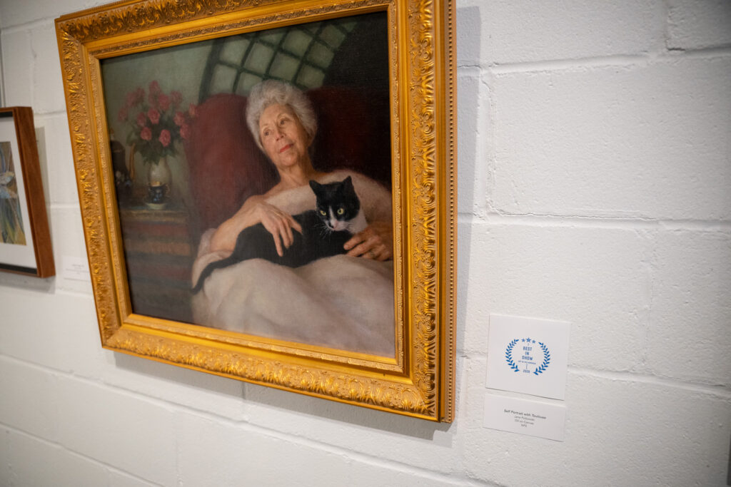 Jane Polkowski winning an award for her artwork Self Portrait with Toulouse being selected as Best in Show at the GFAA Gallery.