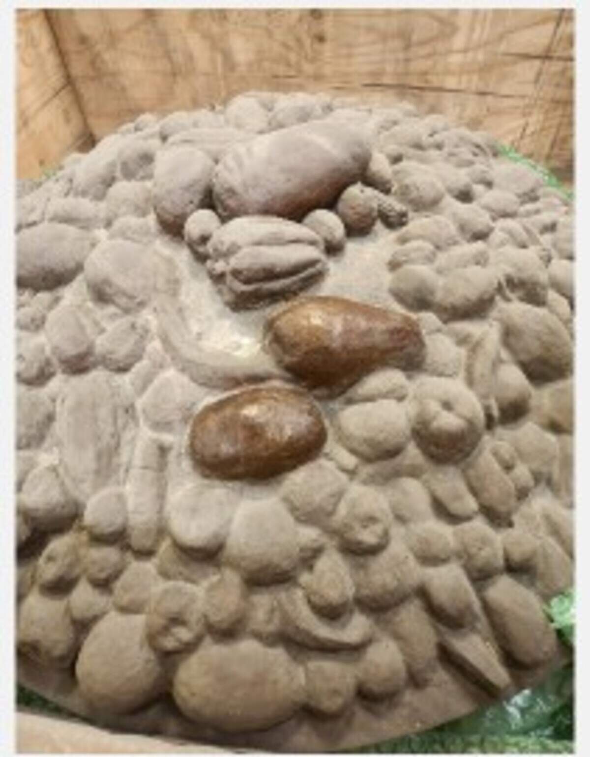 Dust removed from bowl of fruit, part of Las Tarascas sculpture, shows its bronze color. The sculpture, a gift in 2013 from Morelia, Mexico, had been in storage for 13 years.