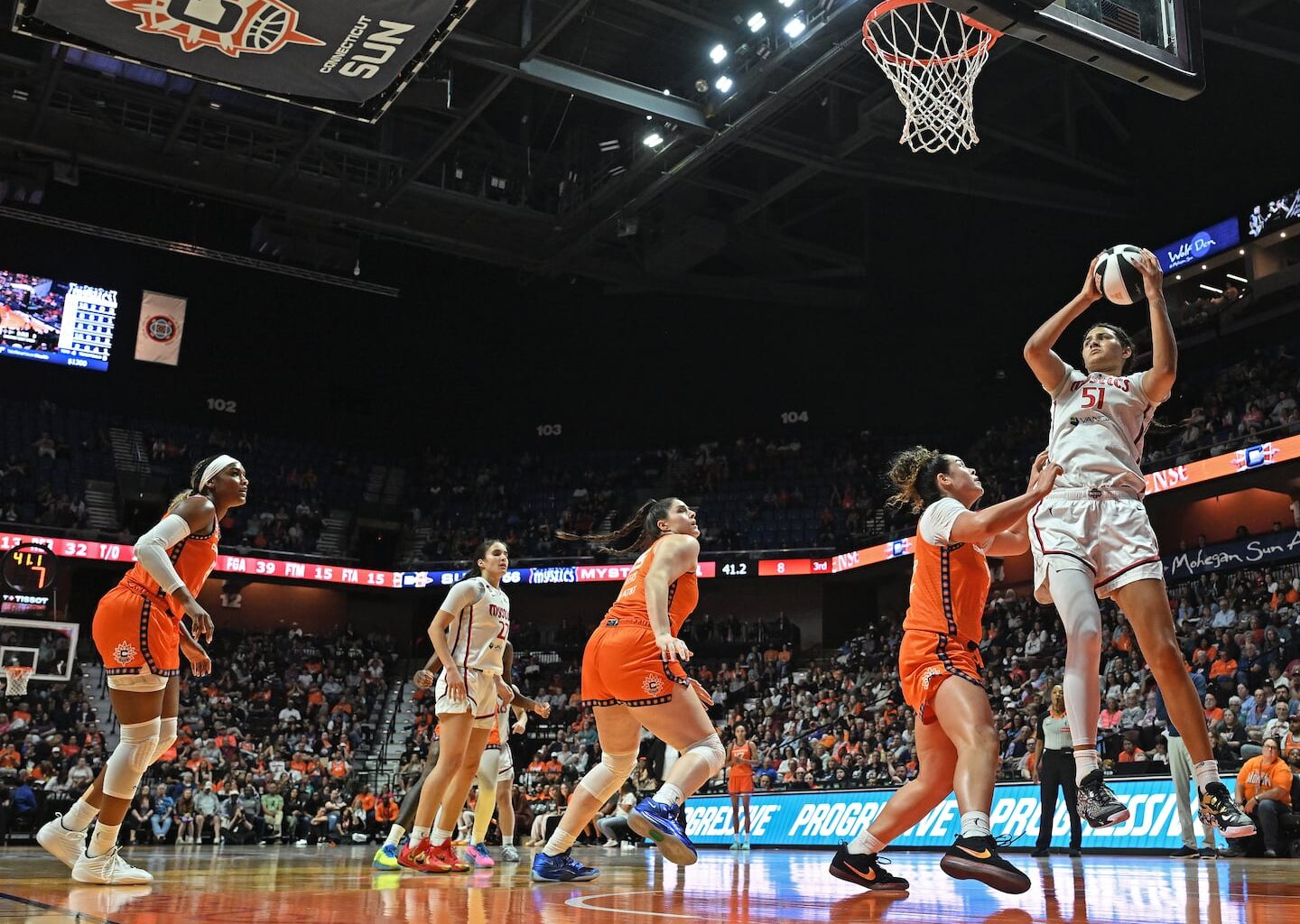 After helping UCLA win the national championship, Lauren Betts (right) had 13 points in her first pro start for the Washington Mystics in a win over the Connecticut Sun on Wednesday night.