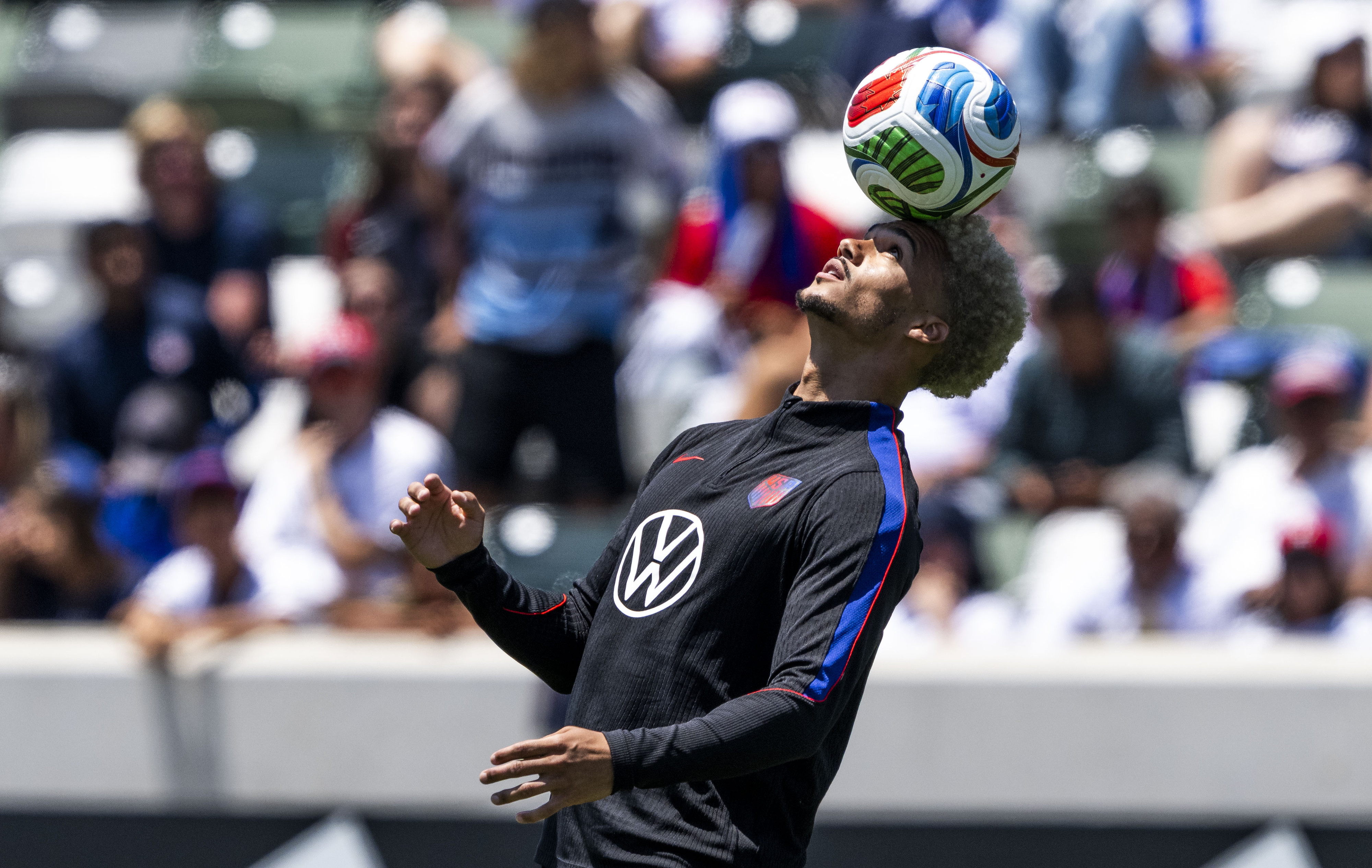 Antonee Robinson balances a ball on his head at the...