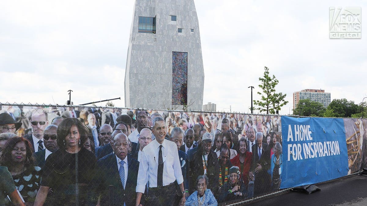 Fence banner showing Barack Obama outside the Obama Presidential Center.