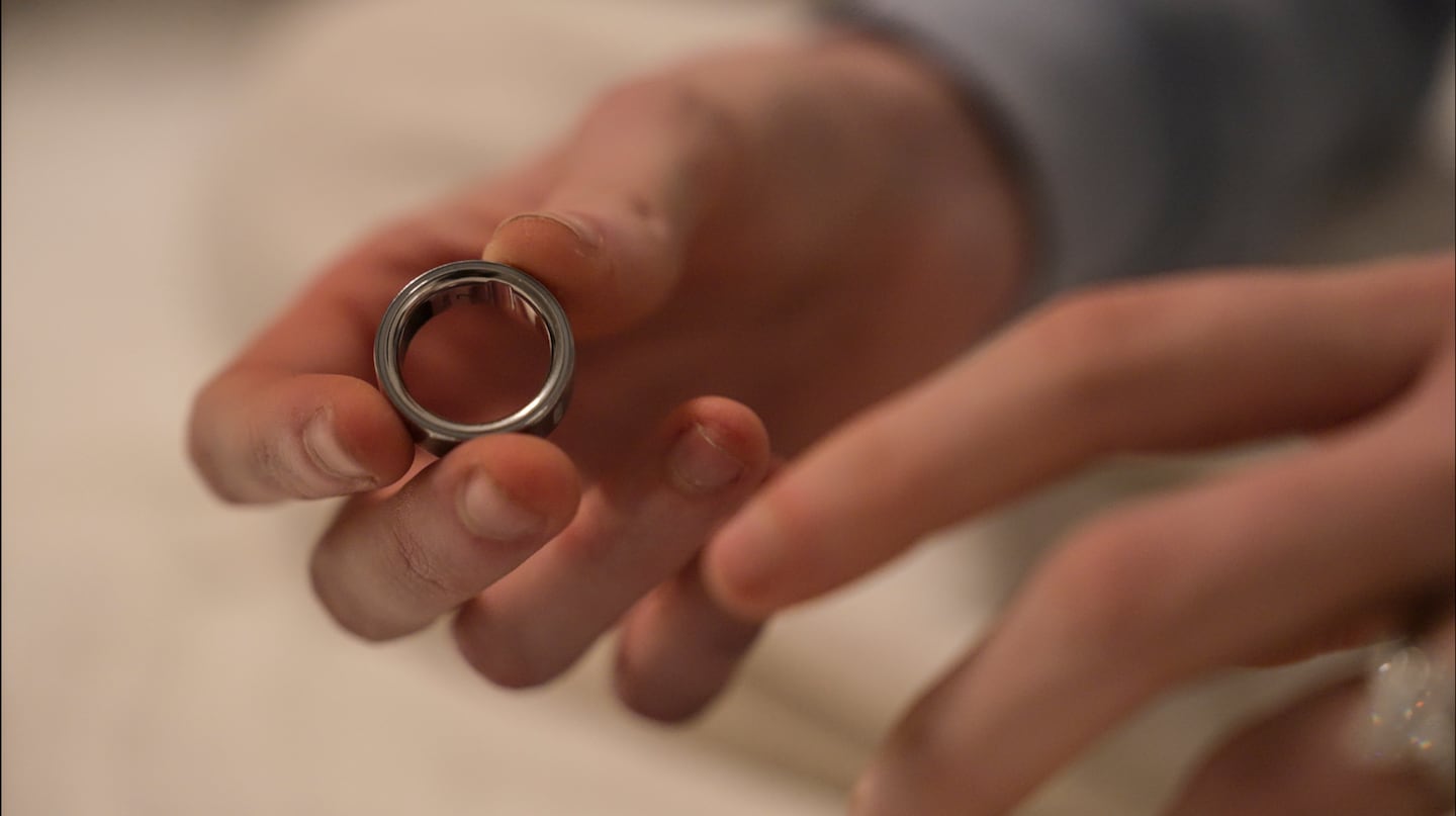 Middle school teacher Kate Stoye puts on an Oura ring, a wearable sleep tracking device in Hiram, Ga.