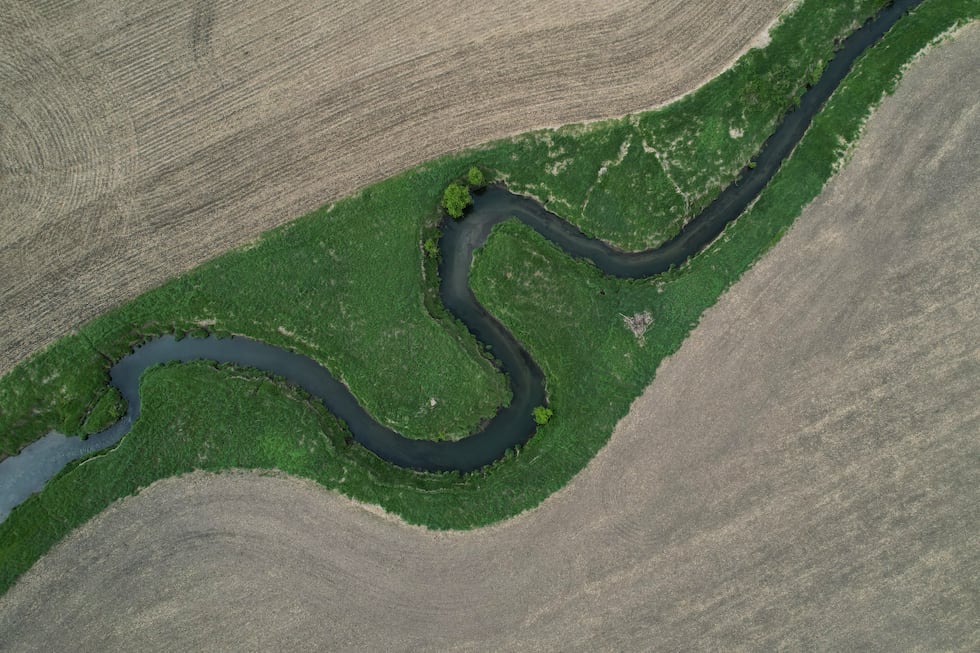A stream cuts through a farm field Thursday, May 7, 2026, near Marshalltown, Iowa. (AP...