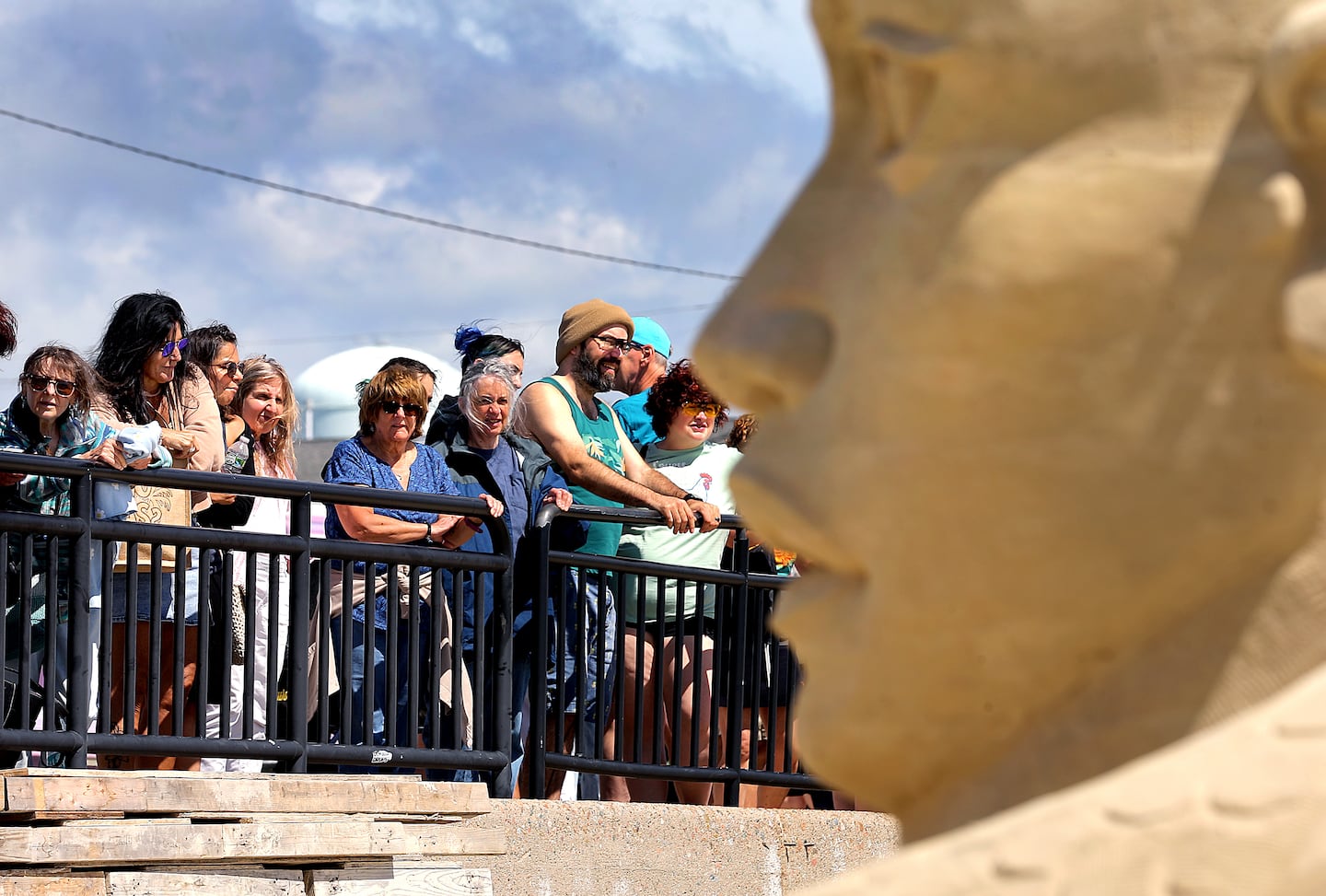 People look on from above Hampton Beach during the 26th Annual Hampton Beach Master Sand Sculpting Classic.