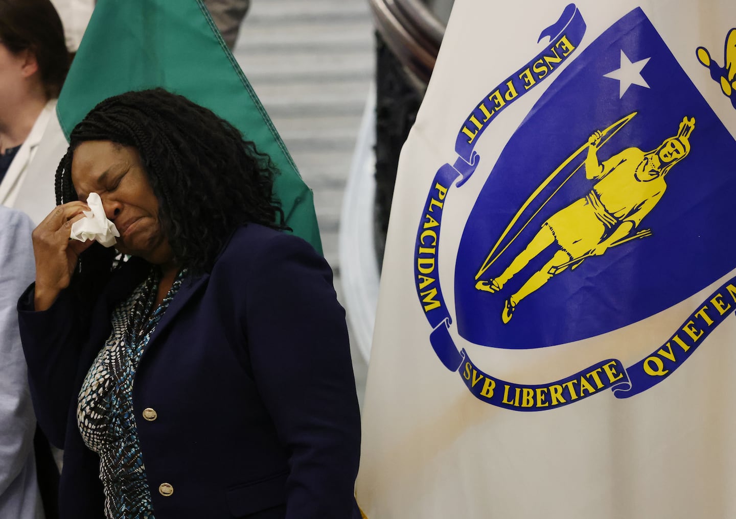 Geralde Gabeau, founder of IFSI-USA, wipes away tears after speaking at a press conference at the State House Thursday about the Supreme Court decision to overturn TPS for Haitians and Syrians.