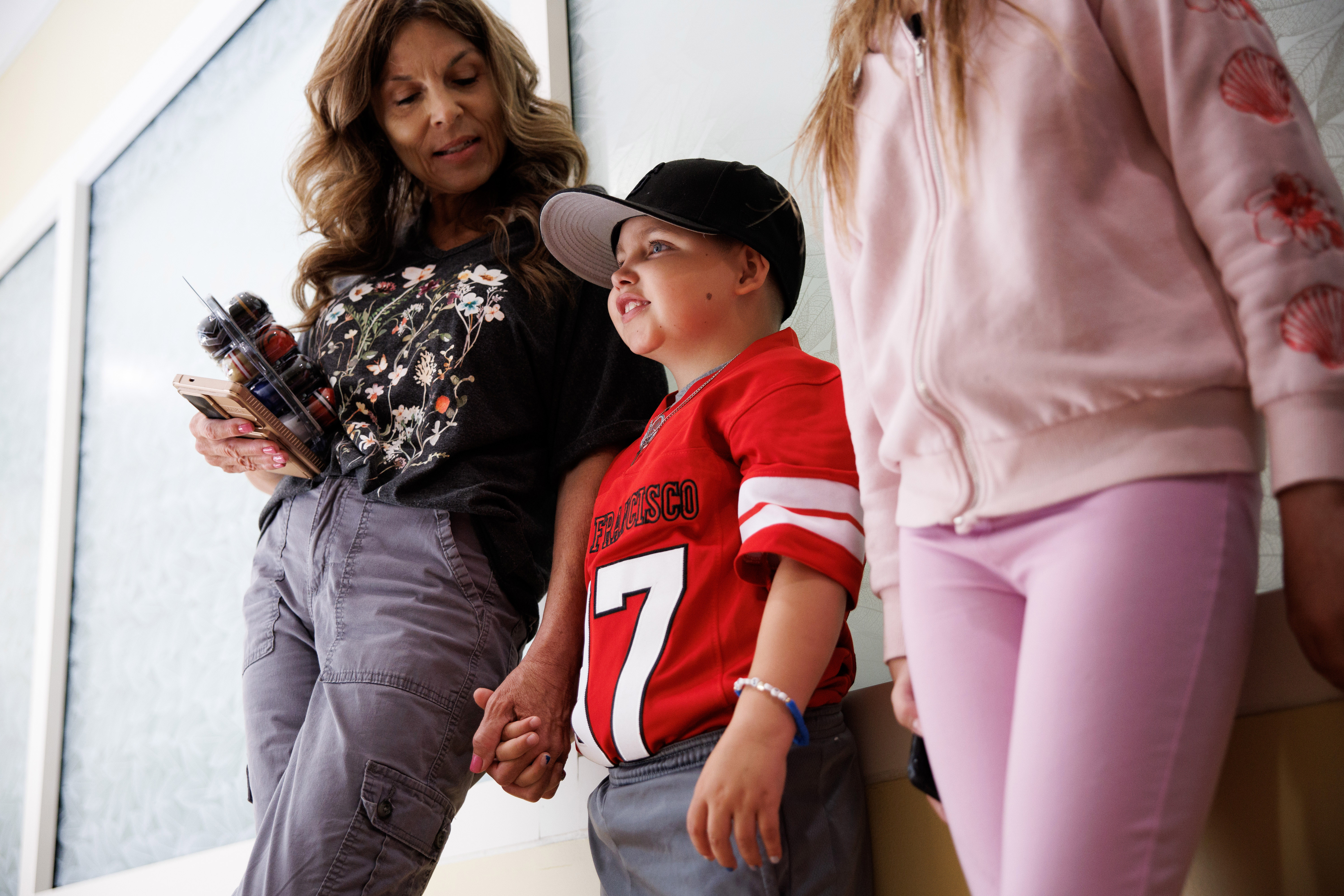 Patient Stephen De La Torre, 7, waits with his family...