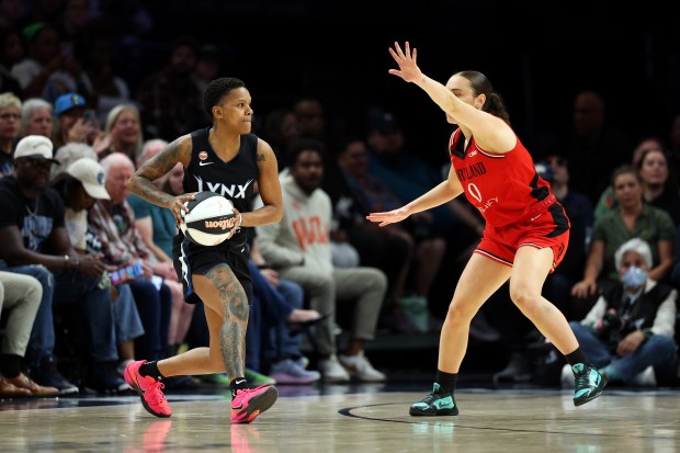 Courtney Williams of the Lynx passes the ball against Carla Leite of the Portland Fire in Monday's game at Target Center. (Photo by David Berding/Getty Images)