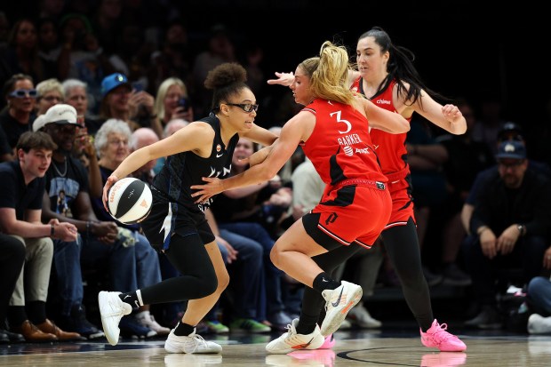 Olivia Miles of the Lynx dribbles the ball against Sarah Ashlee Barker (3) and Megan Gustafson of the Portland Fire in Monday's game at Target Center. (Photo by David Berding/Getty Images)
