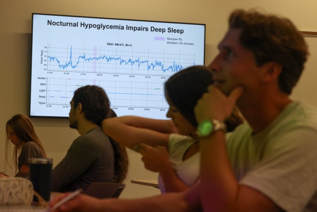 Student Rylan Breneman touches her Dexcom continuous glucose monitor attached to her arm while she and other students attend the Metabolic Health Analytics class at UCSD in La Jolla on Tuesday, June 02, 2026. (Hayne Palmour IV / For The San Diego Union-Tribune)