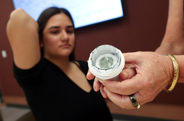 Student Jaidy Leyva holds up her arm as Mary Boyle, Ph.D, professor of the Metabolic Health Analytics class, shows the Dexcom continuous glucose monitor before placing it on Leyva's arm at UCSD in La Jolla on Tuesday, June 02, 2026. (Hayne Palmour IV / For The San Diego Union-Tribune)