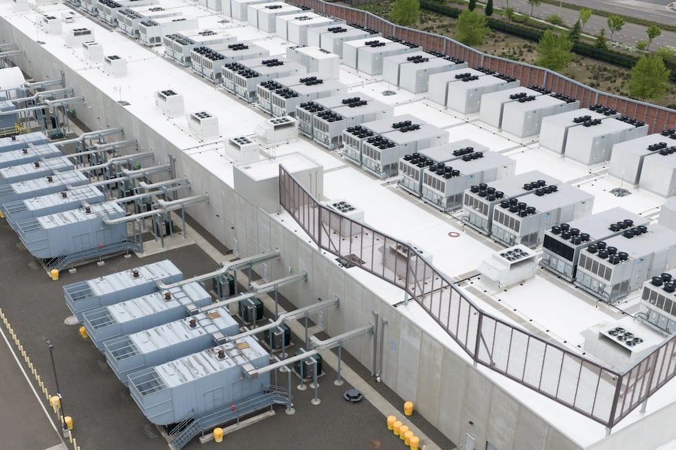 Fans that are part of a cooling system are seen on the roof of a data center, Monday, April...