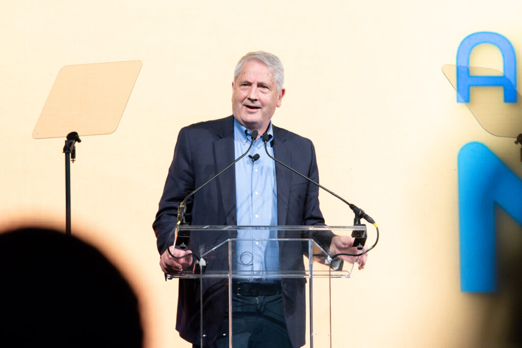 Dr. Ken Duckworth speaking at a podium during NAMICon