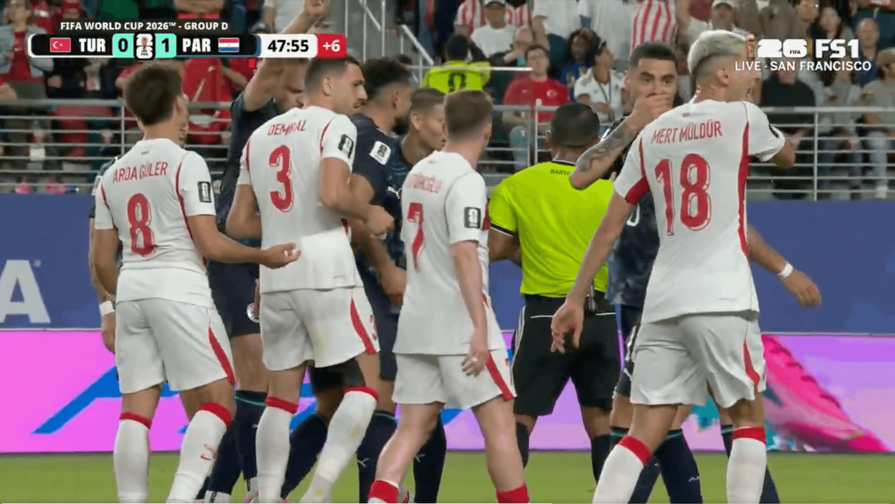 A screenshot of Almiron covering his mouth while talking to Mulder