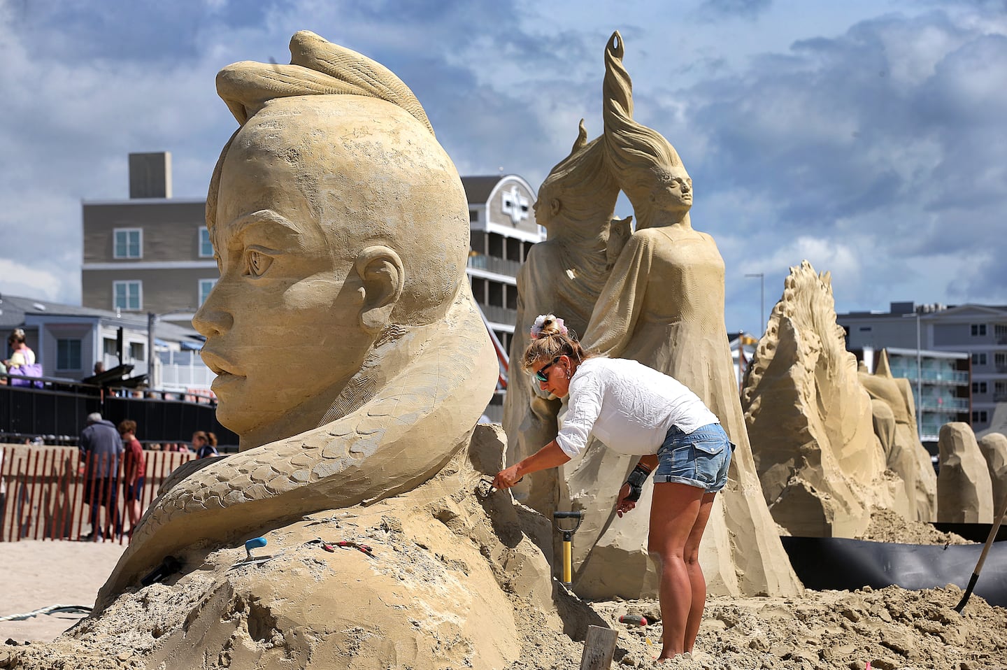 Agnese Rudzite from Latvia works on her sand sculpture called "Revival" during the 26th Annual Hampton Beach Master Sand Sculpting Classic on Saturday, June 20, 2026.