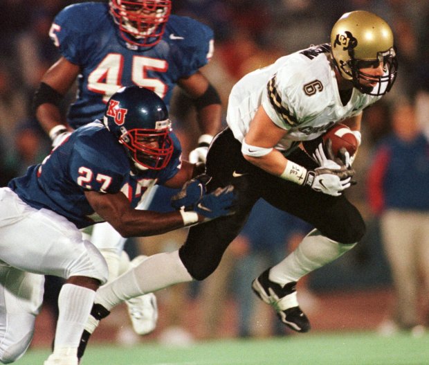 Colorado wide receiver Darrin Chiaverini (9) brings in a Mike Maschetti pass while covered by Kansas safety Michael Allen (27) during the second quarter Saturday, Oct. 24, 1998, in Lawrence, Kan. (AP Photo/Orlin Wagner)