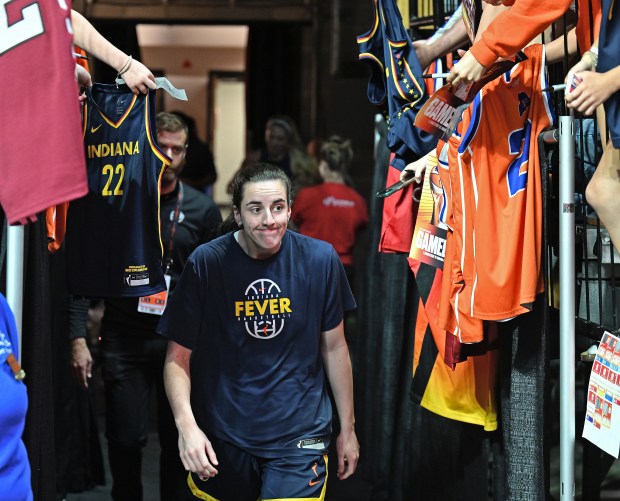 Caitlin Clark #22 of the Indiana Fever ducks autograph seekers on her way to the court for shoot around before playing the Connecticut Sun at Mohegan Sun Arena on June 13, 2026 in Uncasville, Connecticut. (Sean D. Elliot/Getty Images)