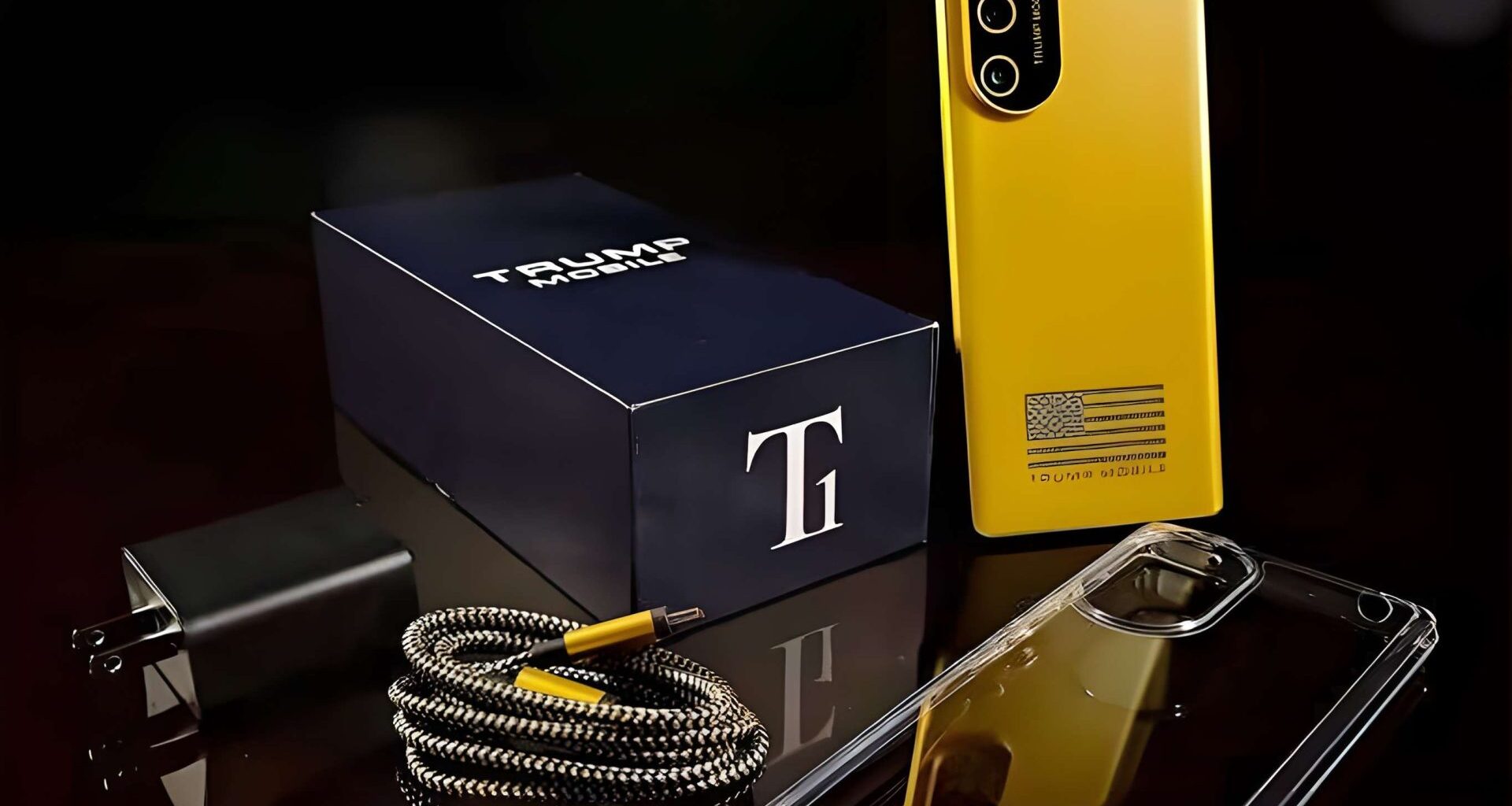 A yellow smartphone labeled 'Trump Mobile' is displayed alongside a charging cable, a plug, a clear phone case, and a branded box with a large 'T' logo.
