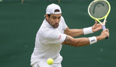 Matteo Berrettini looks to hit a backhand at Wimbledon in 2024.