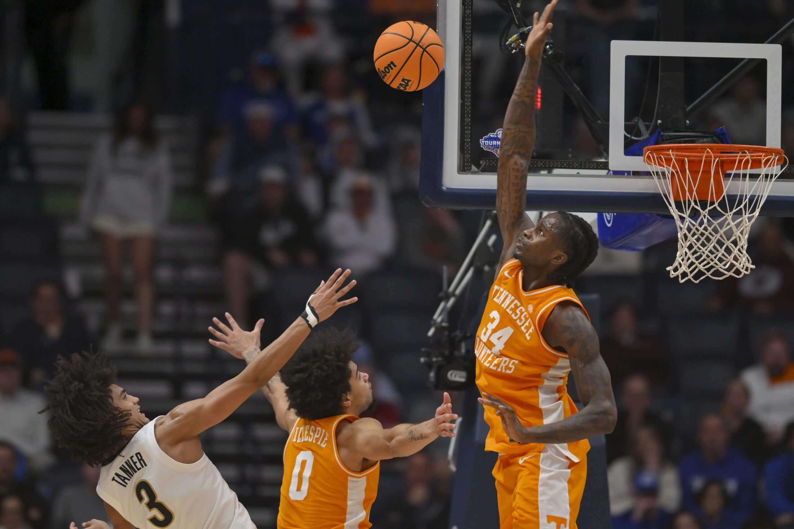 Volunteers forward Felix Okpara blocks the shot of Commodores guard Tyler Tanner.