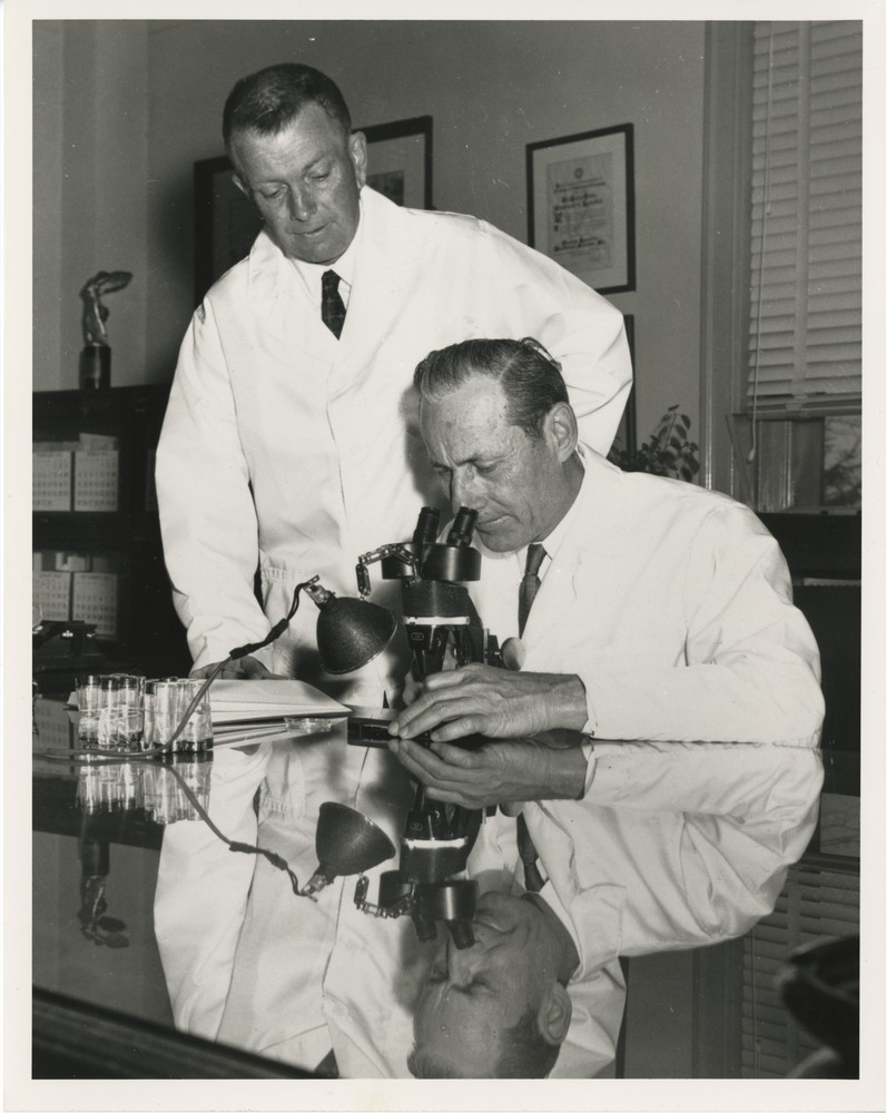 Taken in the 1950s, this photo shows Dr. Edward F. Knipling (seated) and Dr. Raymond C. Bushland in a laboratory.