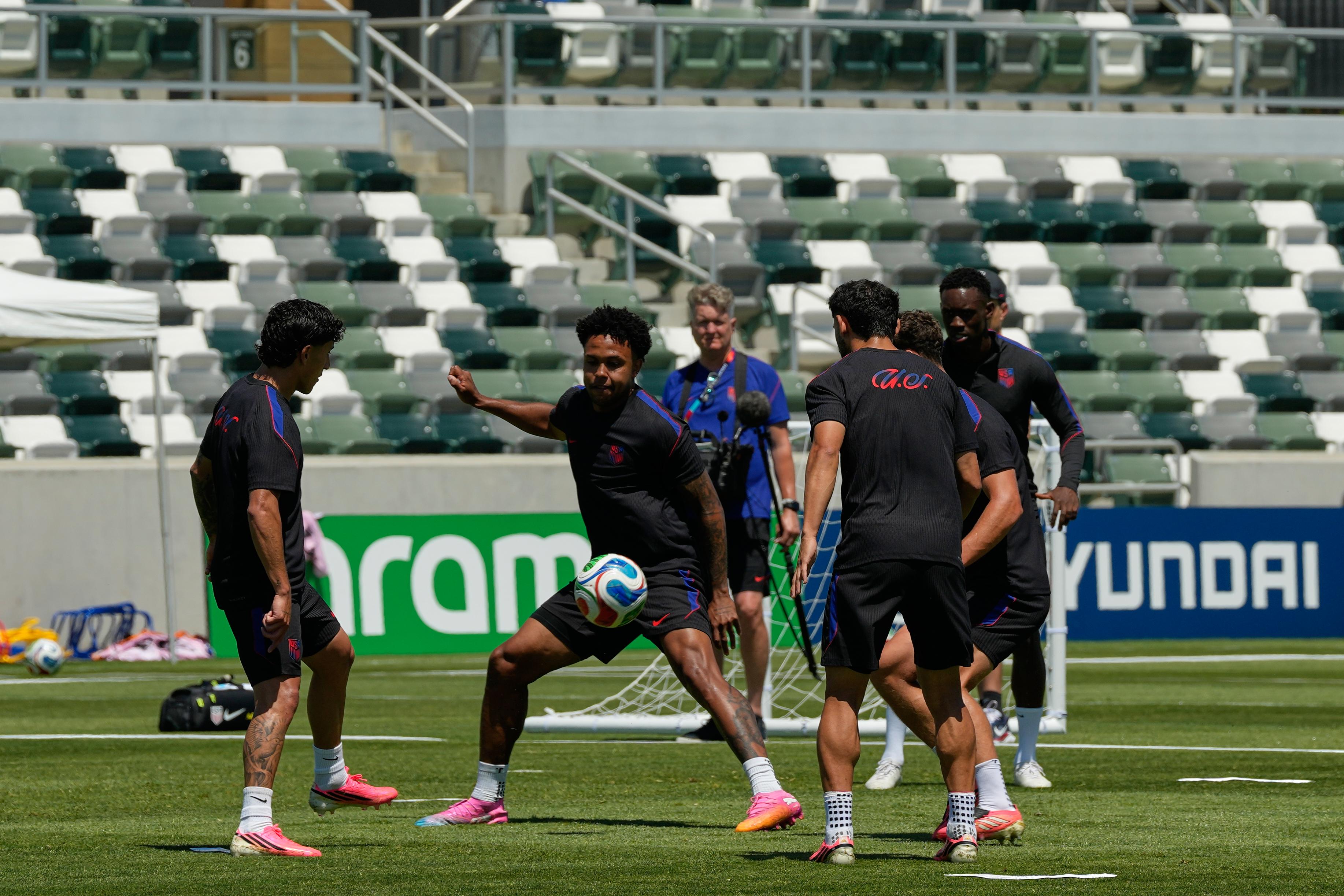 United States’ Weston McKennie, center, and teammates attend a training...