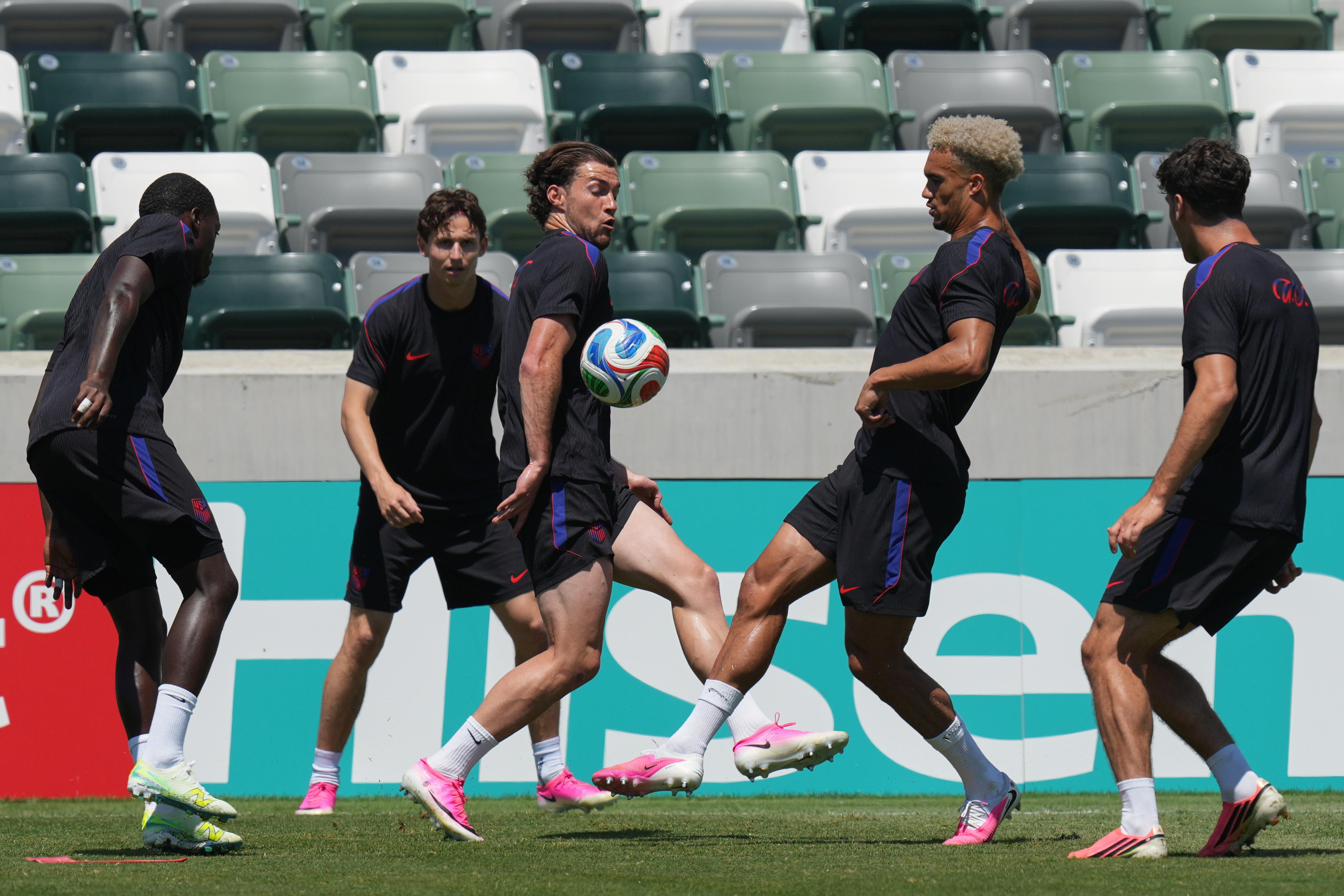United States’ Joe Scally, center, Antonee Robinson, center right, and...