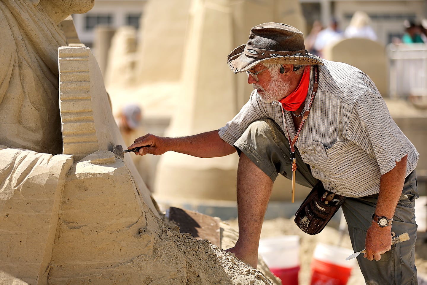 Justin Gordon from Groveland works on his sand sculpture called "One Nation Under God."