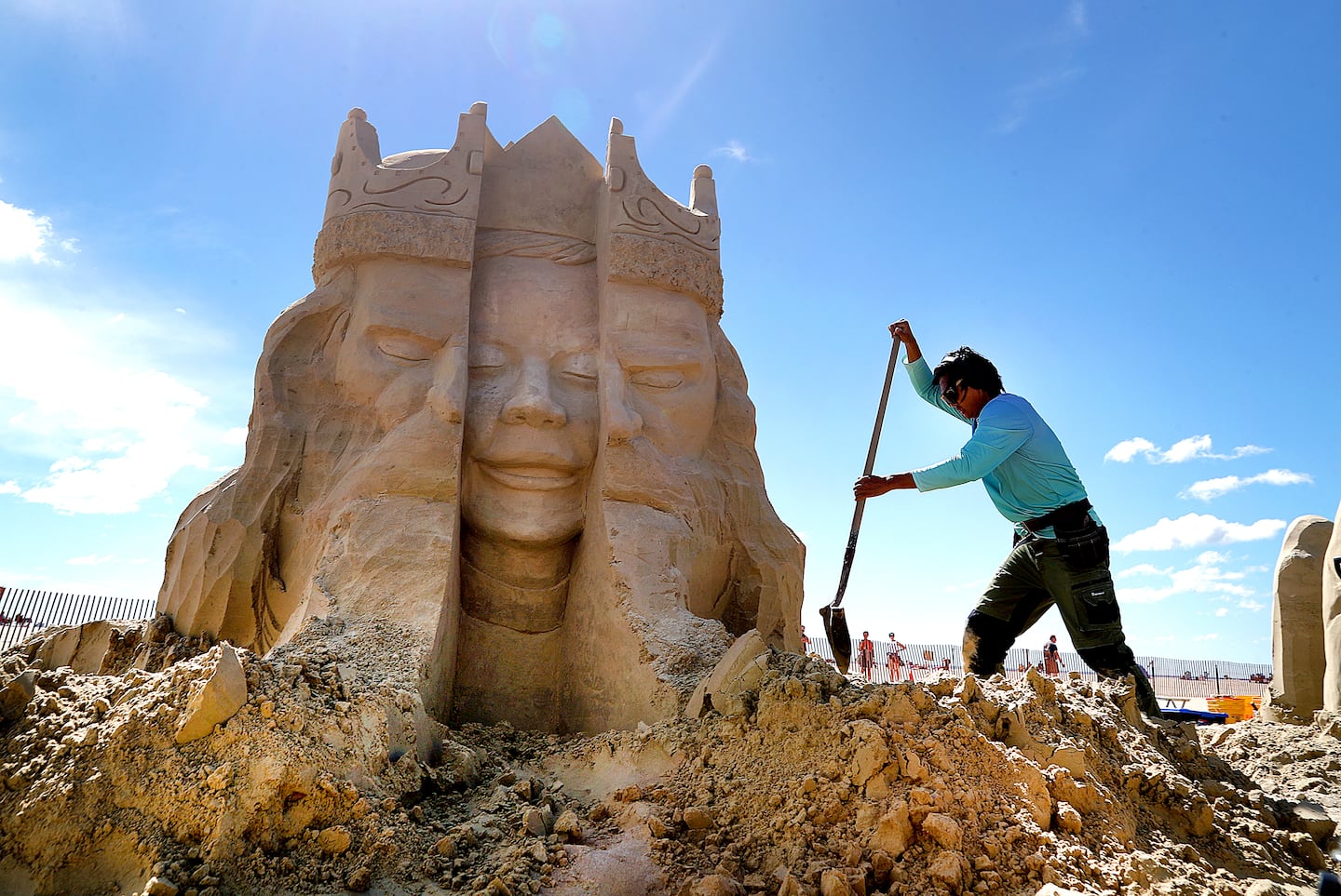 Joon Park from California shovels sand around his sand sculpture called "Born to Be" during the 26th Annual Hampton Beach Master Sand Sculpting Classic on Saturday, June 20, 2026.