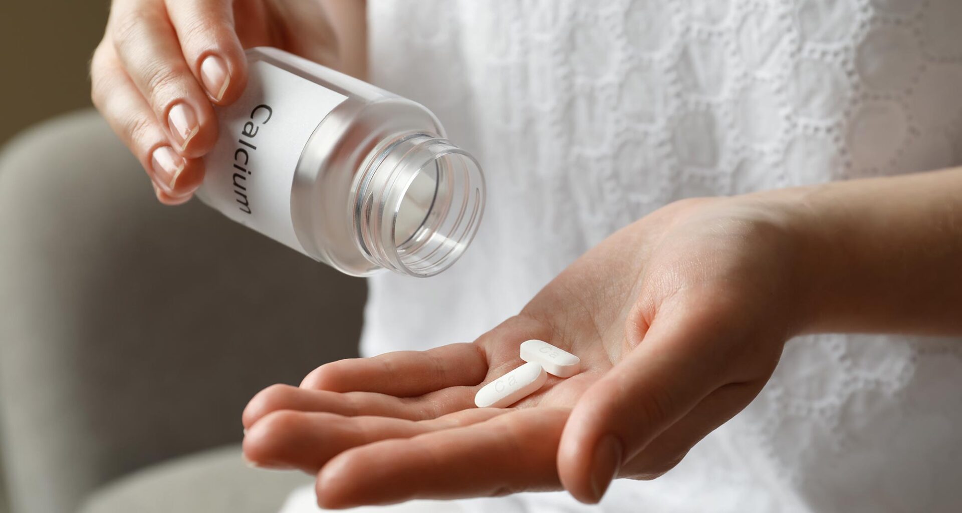 Woman Taking Calcium Supplement Bottle Hand