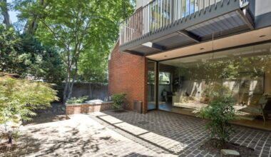 The townhouse's spacious brick patio and walled-in gardens were designed by renowned landscape architect Ian L. McHarg.