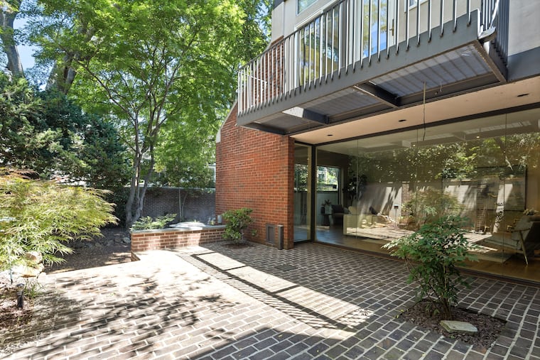 The townhouse's spacious brick patio and walled-in gardens were designed by renowned landscape architect Ian L. McHarg.