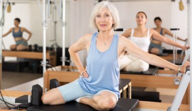 Mature woman in blue activewear in a reformer Pilates class
