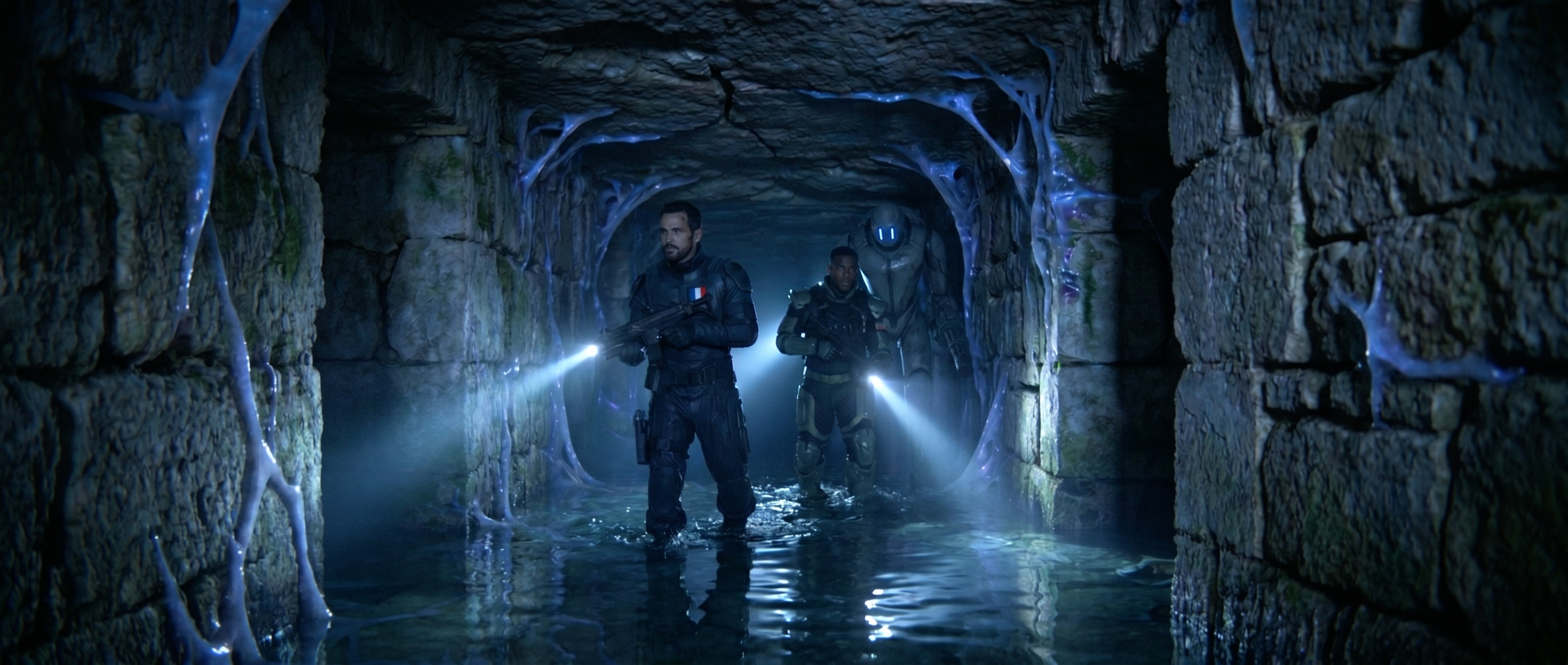 Catacombs AI film; two people with torches explore Paris underground tunnels