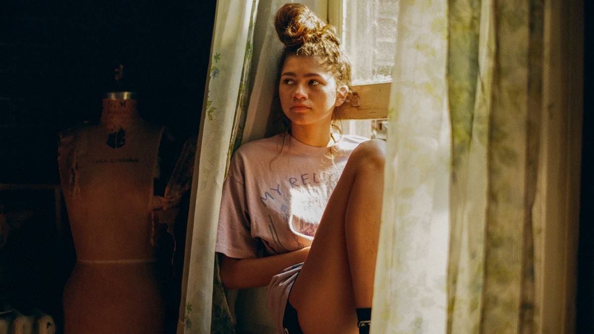 Zendaya standing and looking forward in a promotional image for Euphoria.