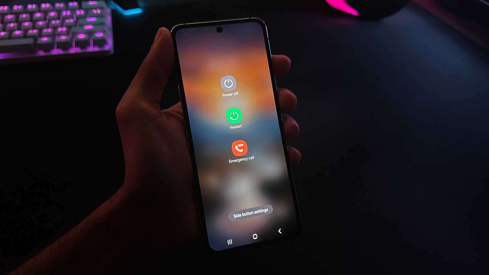 A person holding an Android phone in the hand with power off menu open on it.