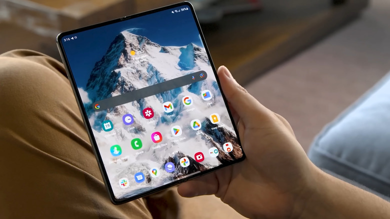 The Google Pixel Fold, unfolded to show its wide home screen.