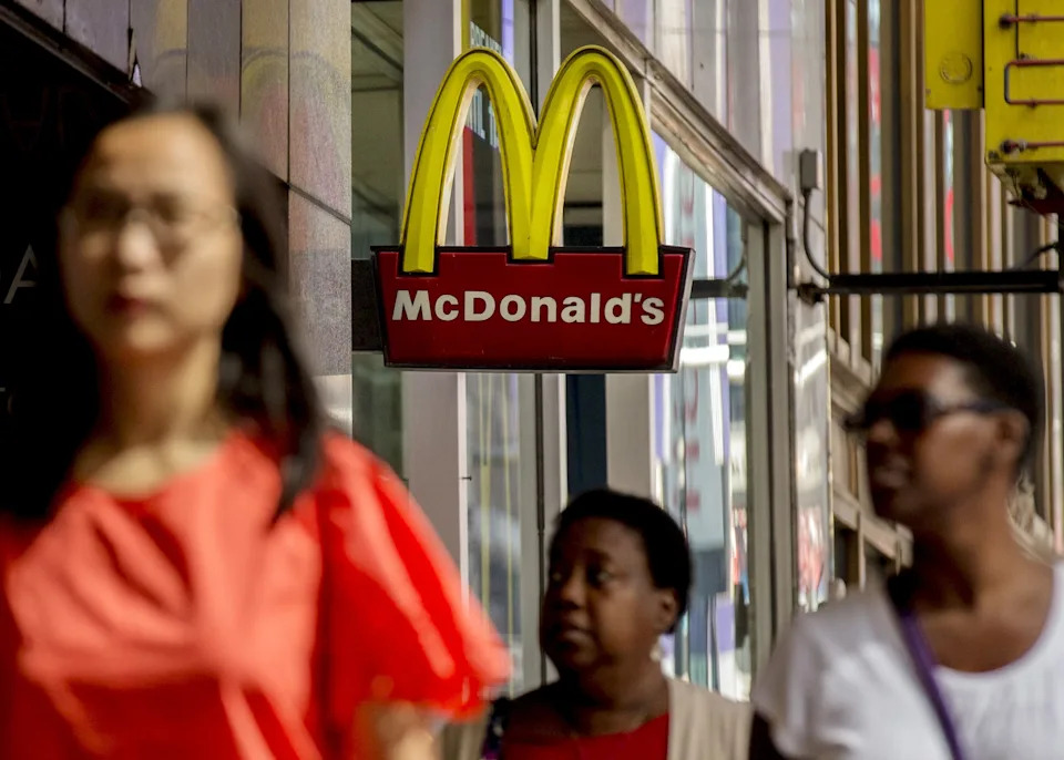The sign for McDonald's in Times Square is seen as people pass by in New York July 23, 2015.
